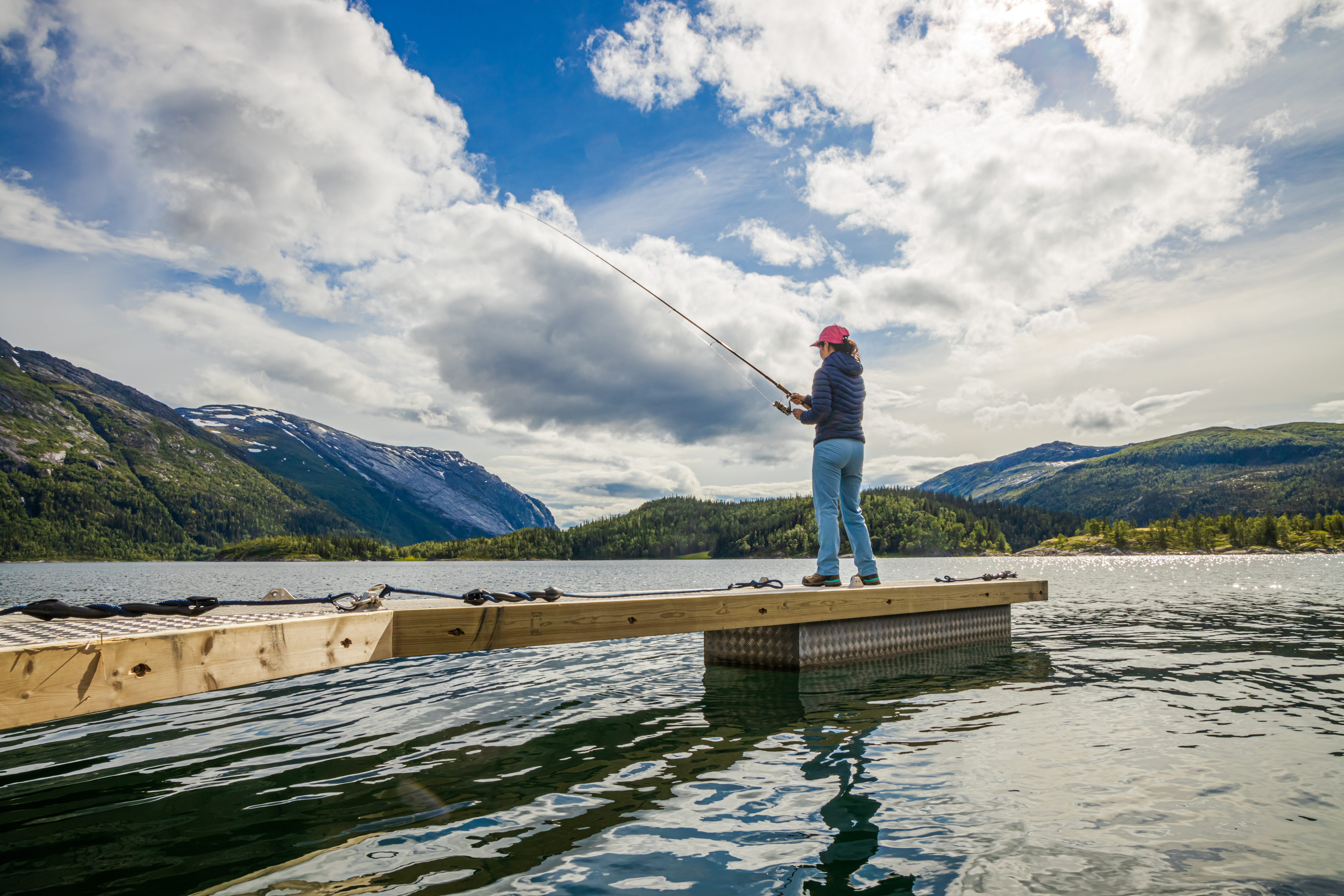 Woman fishing on Fishing rod spinning in Norway.